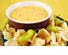 Stock-photo-bowl-of-warm-queso-cheese-dip-with-a-plate-of-tortilla-chips-3144749_medium_medium_medium